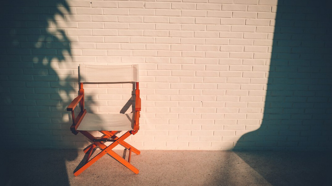 Empty television studio with switched-off lights and a dismantled set