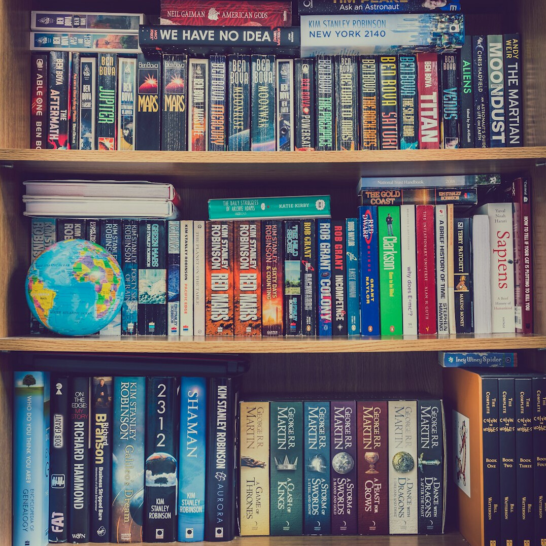 Stack of old VHS videotapes on a shelf