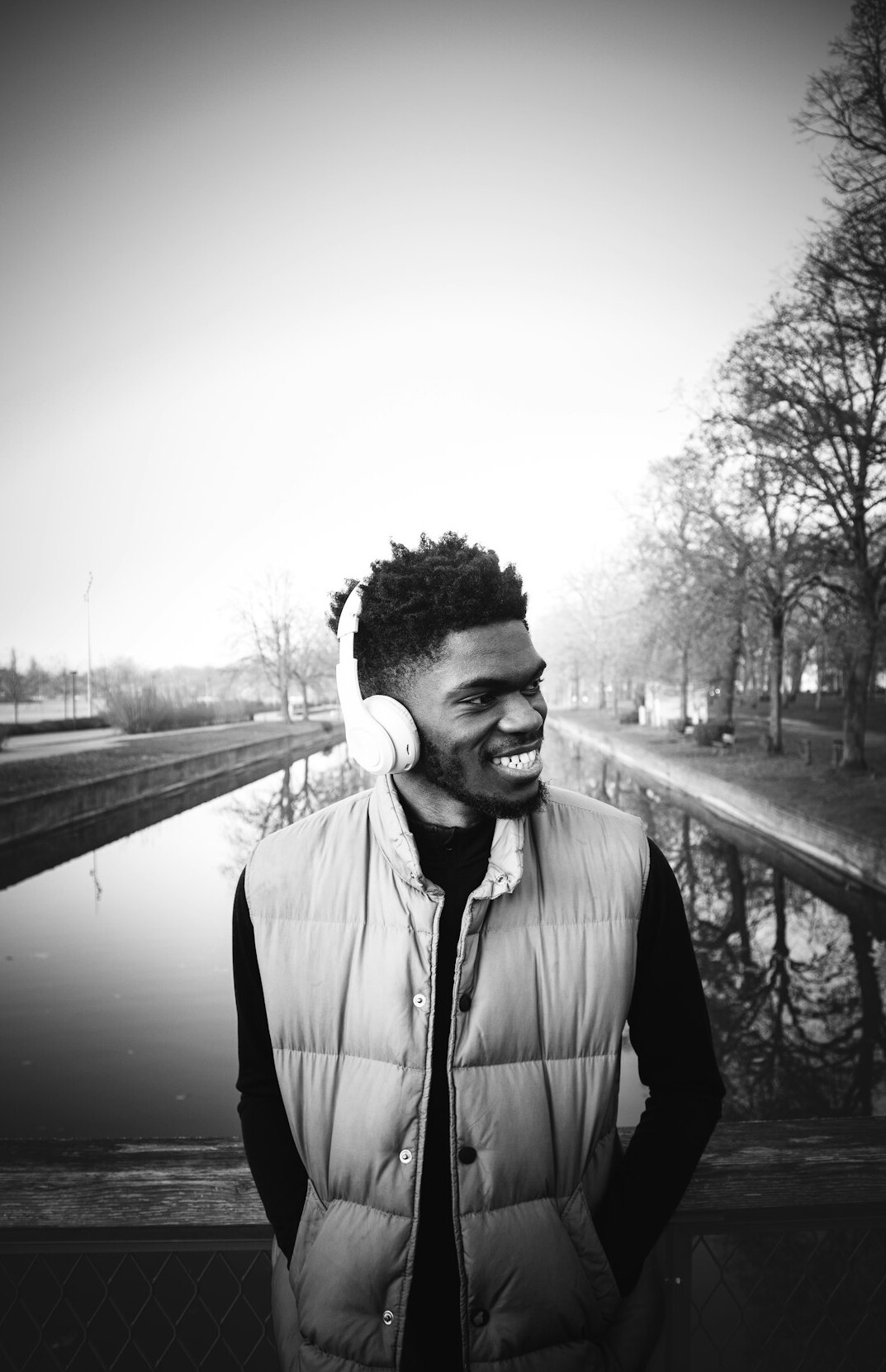 Portrait of a bearded man in his thirties wearing headphones around his neck, video producer