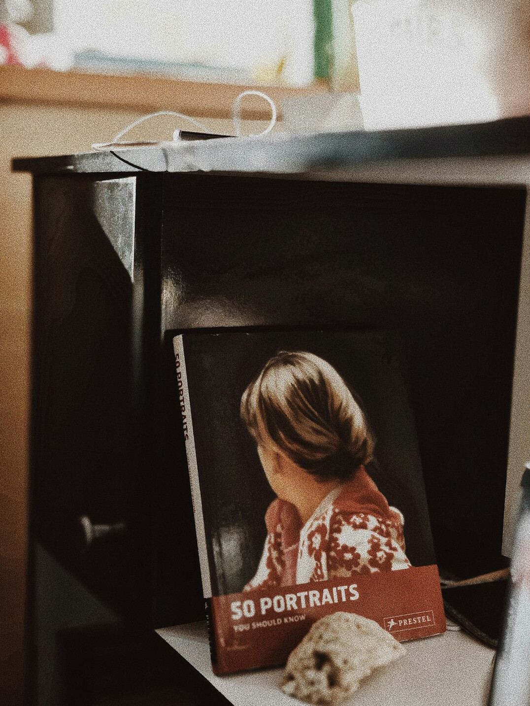 Editorial desk with notebooks, a laptop and printed archive photographs