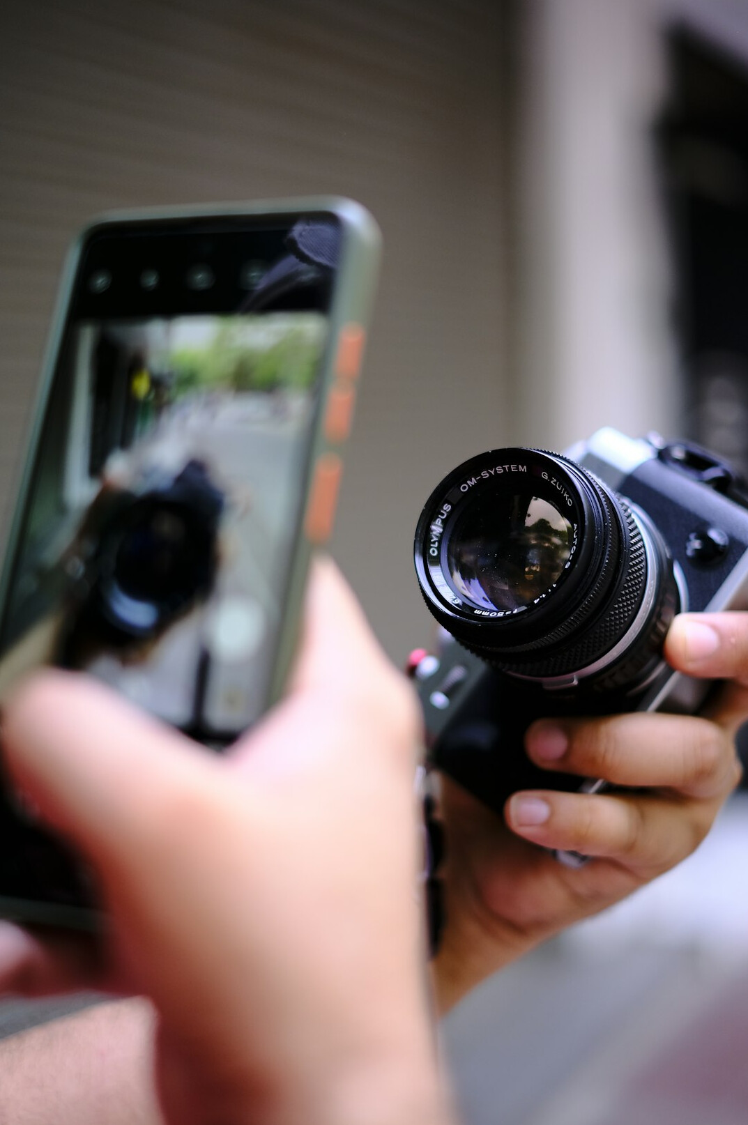 Smartphone and camera filming a short retrospective in a small studio setup